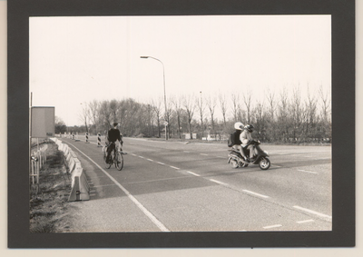 0360-513 De Hoofdstraat in Kesteren richting Rhenen en de afrit N233. Een fiets en een scooter