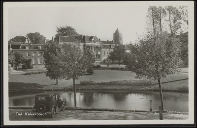 K 2.7 Een deel van het plantsoen met op de achtergrond de huizen van Kalverbos en de toren van de RK Kerk. Op de ...