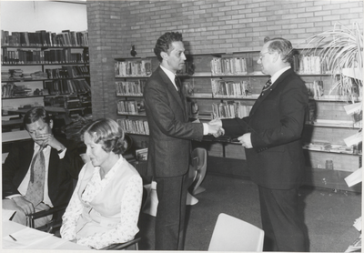 M 2445 Dhr. J. Hijmans (links) drukt de hand van de scheidende voorzitter van de Openbare Bibliotheek mr. S. Wijnperle