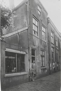 M 3792 Eventueel de lederwinkel het Lederhuis van dhr. A.J. van Rinsum aan het Jodenstraatje 2, op de foto een bewoner ...