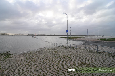 976 Foto van het hoogwater aan de Waalkade in Tiel. De gemeente Tiel heeft het parkeerterrein op de kade afgesloten ...