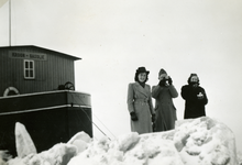 1076 Mobilisatie Kesteren en omgeving: 2 vrouwen en één fotograferende militair op het ijs met links de voorplecht van ...