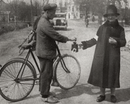 325 Een mevrouw met collectebus vraagt man met fiets een bijdrage voor de getroffenen van de brand te Rossum. Op de ...