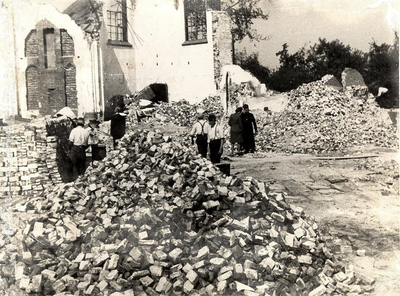 20-237 Sloop van de door oorlog zwaar beschadigde rooms-katholieke kerk. De stenen worden schoongebikt en hergebruikt